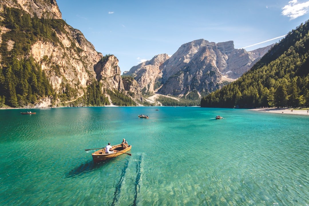 Lago di Braies emerald water with boathouse and reflections