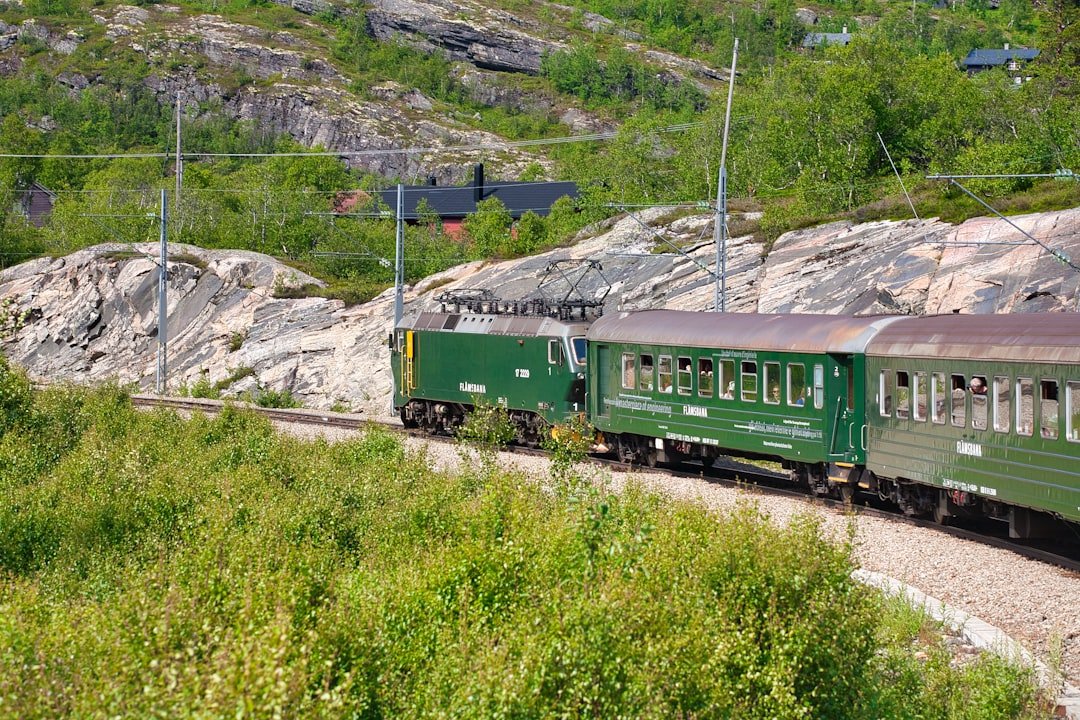 Flam railway train in waterfall lined valley