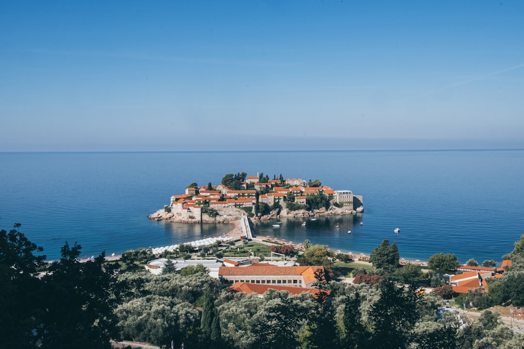 Sveti Stefan islet with terracotta roofs and connecting causeway